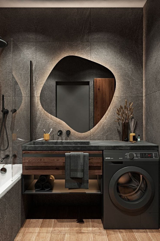 Modern bathroom with dark wooden vanity, round mirror, and washing machine.