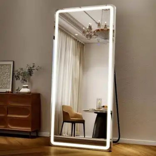 Large illuminated floor mirror in a room with furniture and decor.