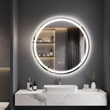 Bathroom vanity with a round illuminated mirror on a gray wall.