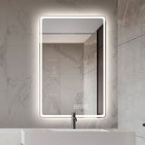 Bathroom mirror with LED lighting on a marble wall