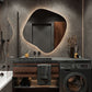 Modern bathroom with dark wooden vanity, round mirror, and washing machine.