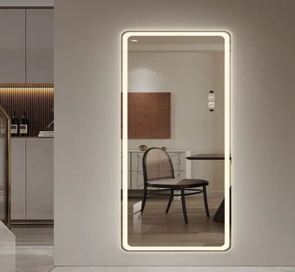 Full-length mirror with LED lighting on a wall in a modern interior setting.