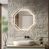 Bathroom vanity with a modern lighted mirror on a stone wall.