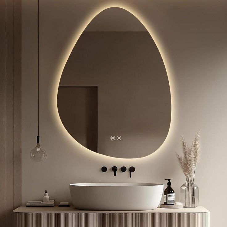 Modern bathroom with a round illuminated mirror, sink, and decorative elements.