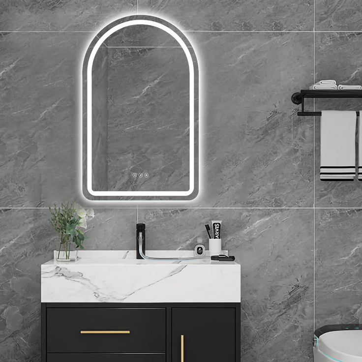 Bathroom vanity with mirror and sink against a gray tiled wall.