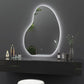 Modern vanity setup with an oval LED mirror on a dark wall.