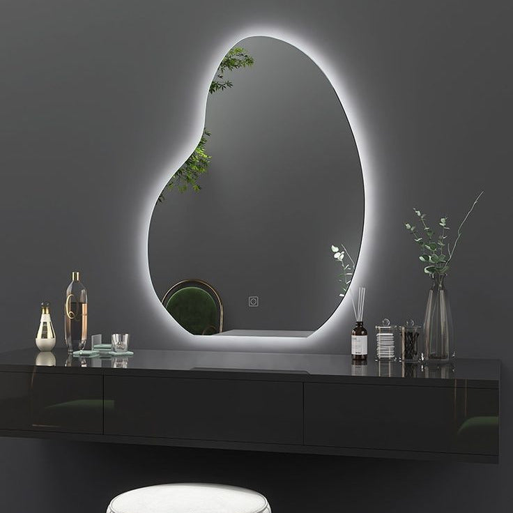 Modern vanity setup with an oval LED mirror on a dark wall.
