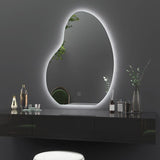 Modern vanity setup with an oval LED mirror on a dark wall.