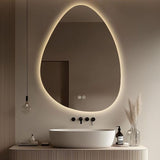 Modern bathroom with a round illuminated mirror, sink, and decorative elements.
