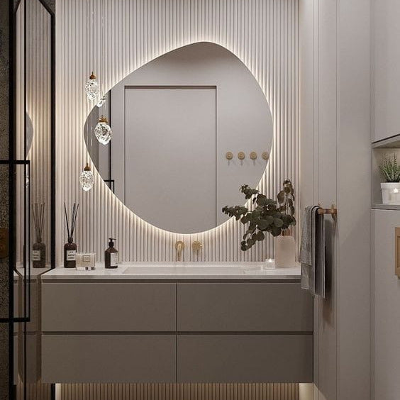 Modern bathroom vanity with round mirror, lights, and decorative elements.