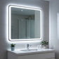 Bathroom vanity with illuminated mirror, sink, and decorative plants.