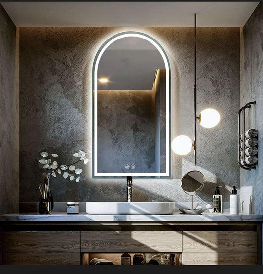 Modern bathroom vanity with illuminated mirror and decorative elements.