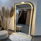 Floor mirror with LED lighting in a room setting with decor elements.