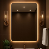 Bathroom vanity with illuminated mirror, sink, and decorative elements.