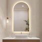 Modern bathroom vanity with illuminated mirror and decorative elements.